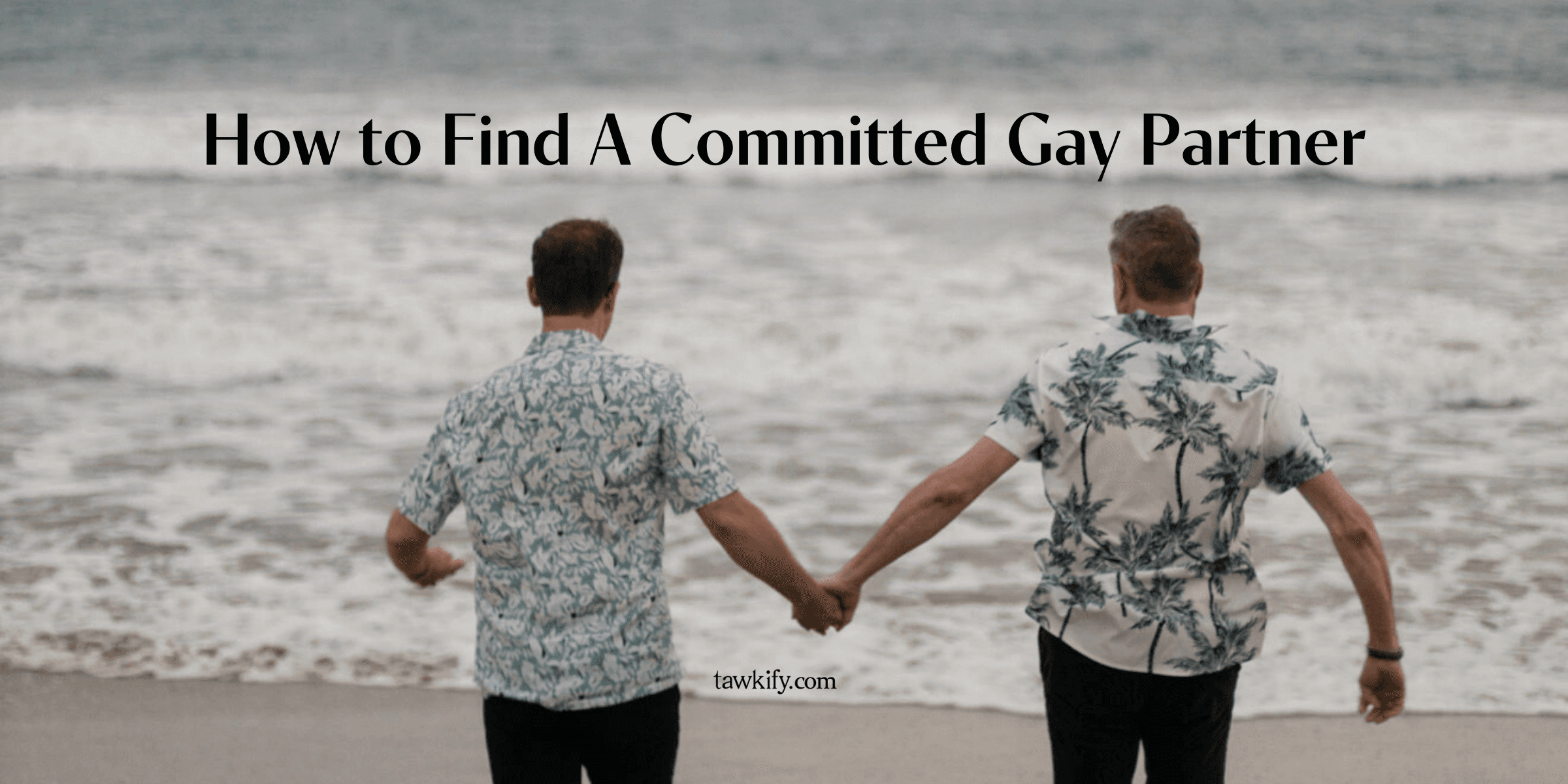 How to find a committed gay partner. A gay male couple in blue Hawaiian print shirts hold hands and run along the beach toward calm ocean waves.